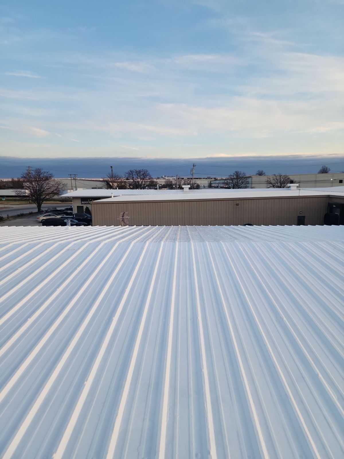 White coated corrugated metal roof at sunset