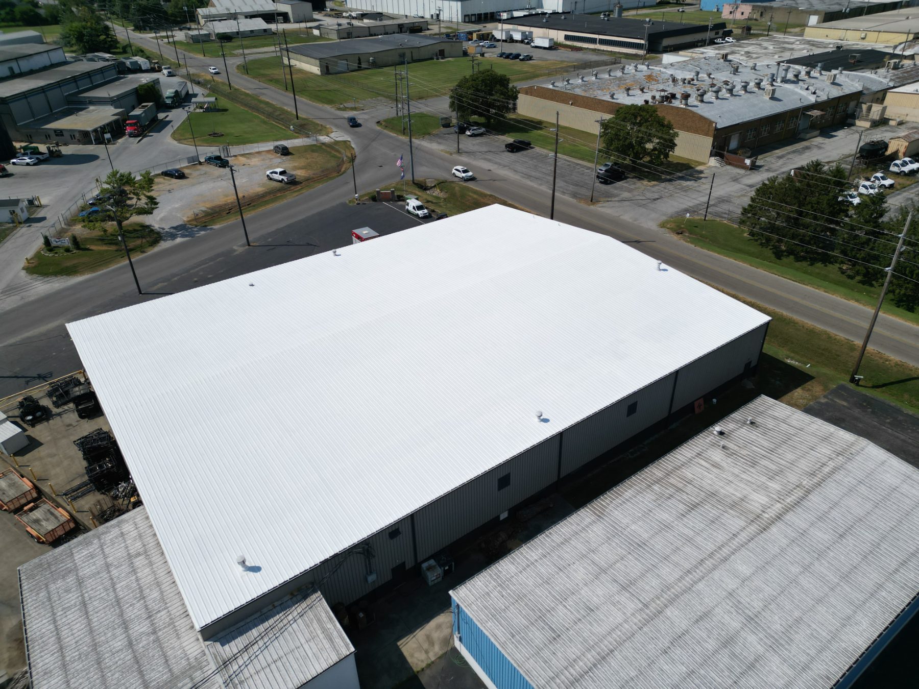 Commercial metal building with a white roof coating by A&R United Construction