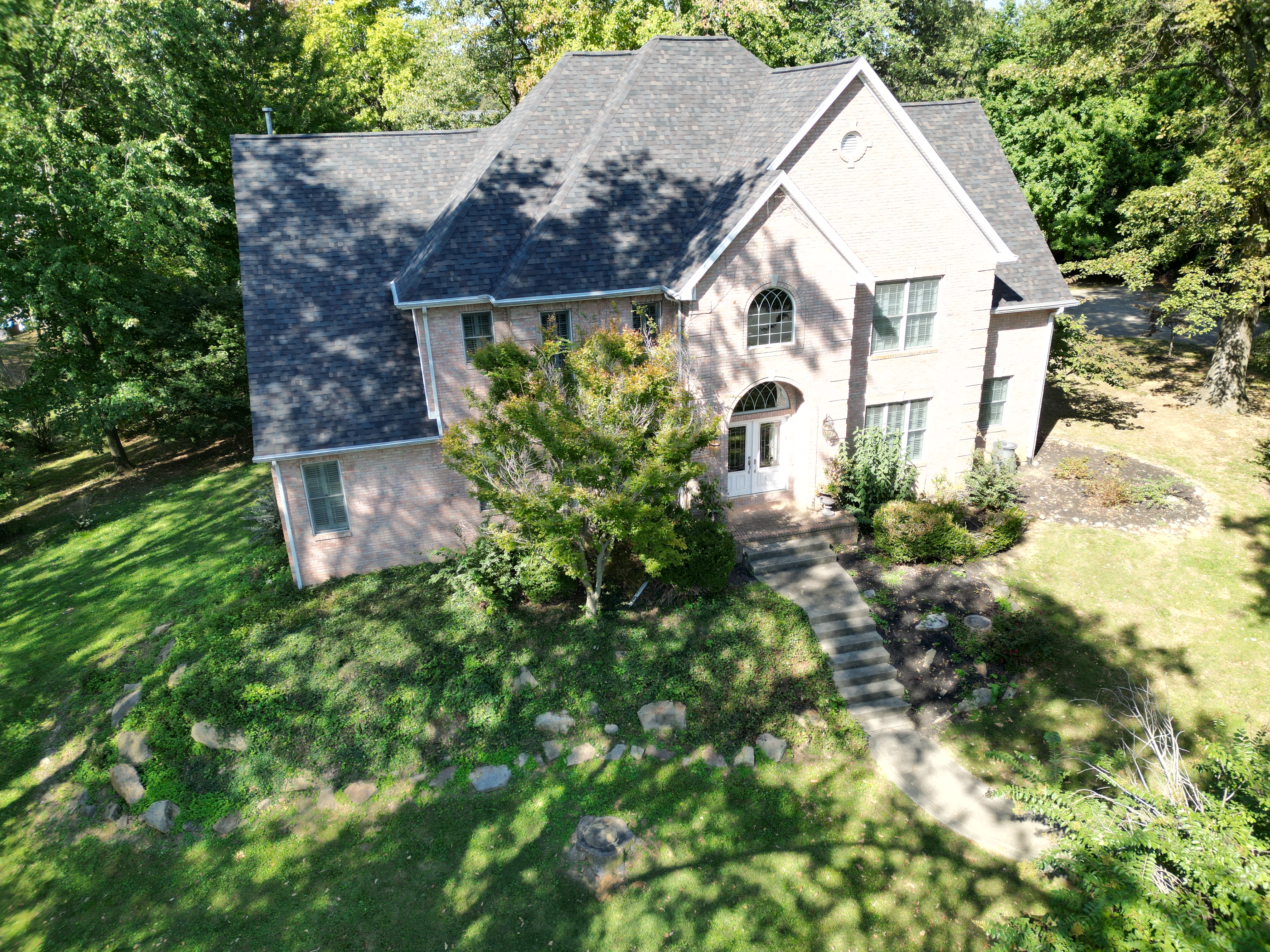 Aerial view of a home with a new roof installed by A&R United Construction