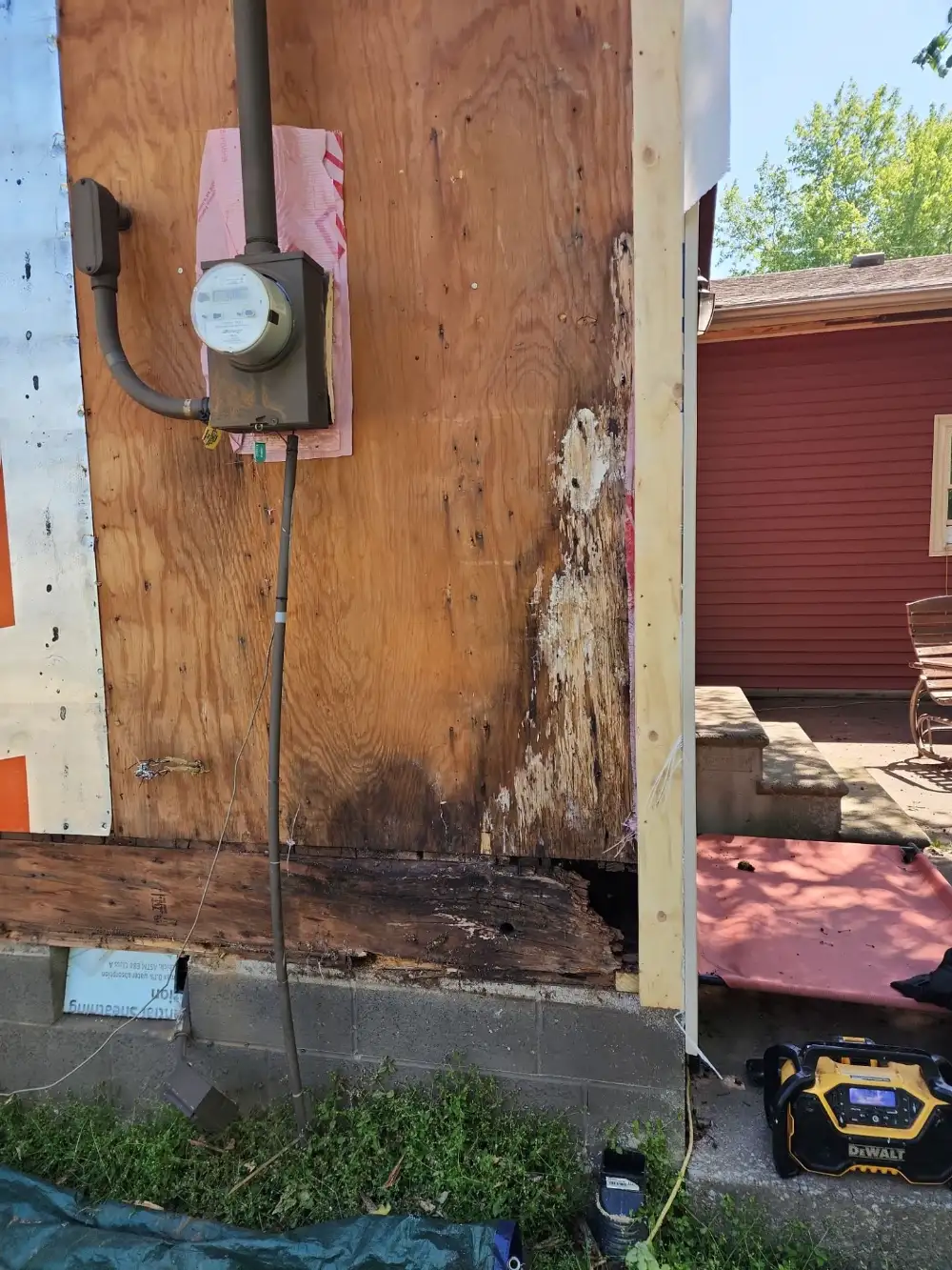 Rotted rim joist and sheathing above a block foundation